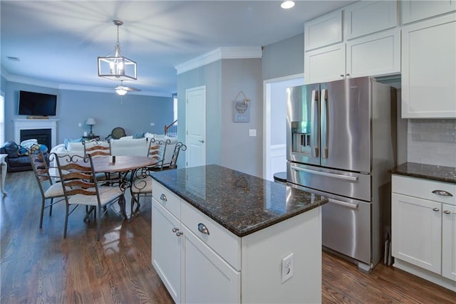 kitchen featuring stainless steel refrigerator with ice dispenser, open floor plan, dark wood-type flooring, white cabinetry, and crown molding