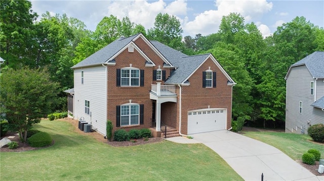 view of front facade featuring a balcony, driveway, an attached garage, brick siding, and a front yard