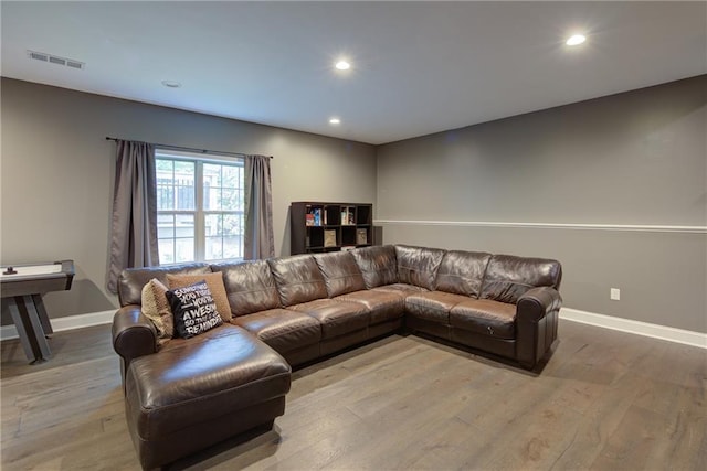 living area featuring recessed lighting, light wood-type flooring, and baseboards