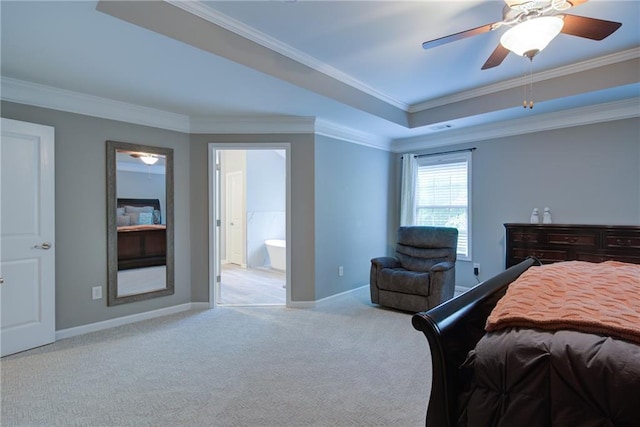 bedroom featuring carpet, crown molding, a tray ceiling, baseboards, and ensuite bathroom