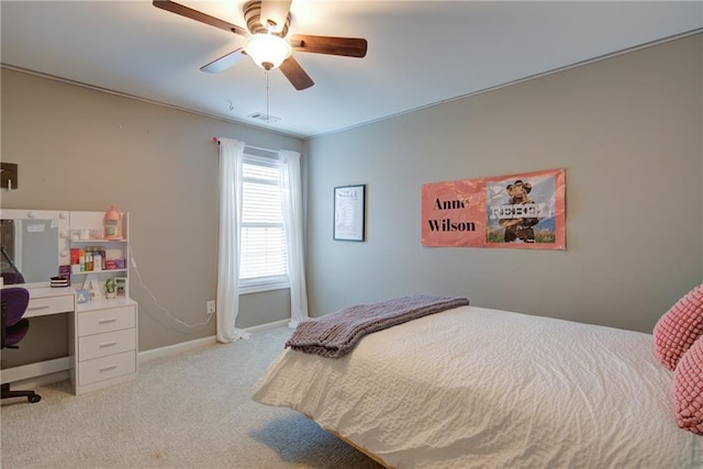 bedroom with light carpet, baseboards, an office area, and ceiling fan