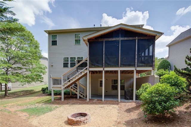 back of house with a fire pit, a sunroom, stairway, and a patio