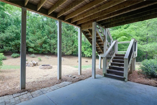 view of patio with stairway and a fire pit