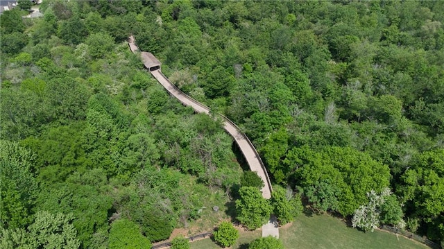 aerial view of property and surrounding area featuring a forest
