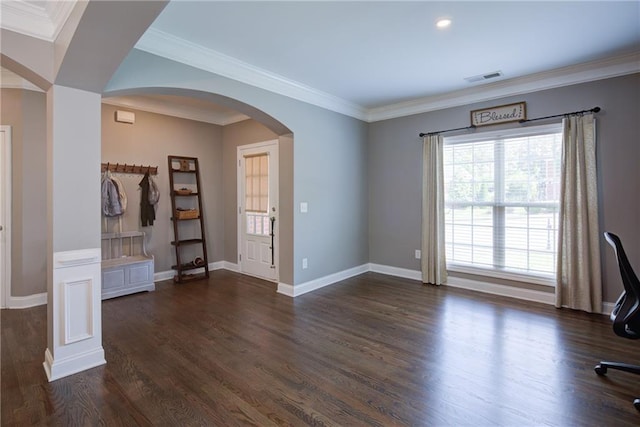 unfurnished living room featuring arched walkways, dark wood-style floors, ornamental molding, baseboards, and recessed lighting