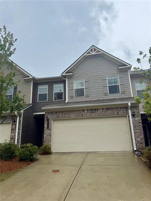 2778 Wild Laurel Ct, Norcross, GA 30071 - view of front of home featuring an attached garage, concrete driveway, and brick siding