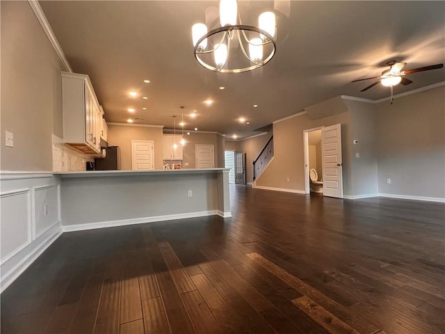 2778 Wild Laurel Ct, Norcross, GA 30071 - kitchen featuring open floor plan, ornamental molding, a chandelier, white cabinetry, and ceiling fan