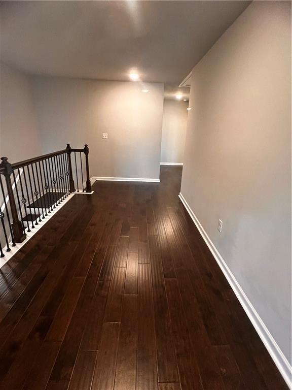2778 Wild Laurel Ct, Norcross, GA 30071 - hallway with hardwood / wood-style flooring, an upstairs landing, and baseboards
