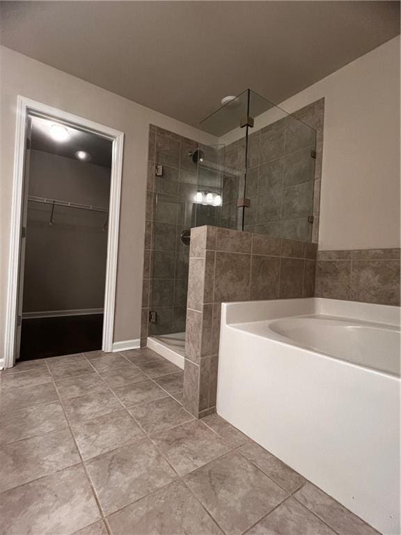 2778 Wild Laurel Ct, Norcross, GA 30071 - full bath featuring a bath, a stall shower, tile patterned flooring, and a walk in closet