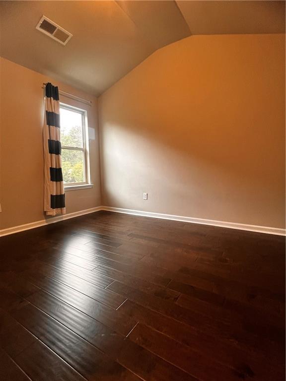 2778 Wild Laurel Ct, Norcross, GA 30071 - spare room with lofted ceiling, dark wood-type flooring, and baseboards