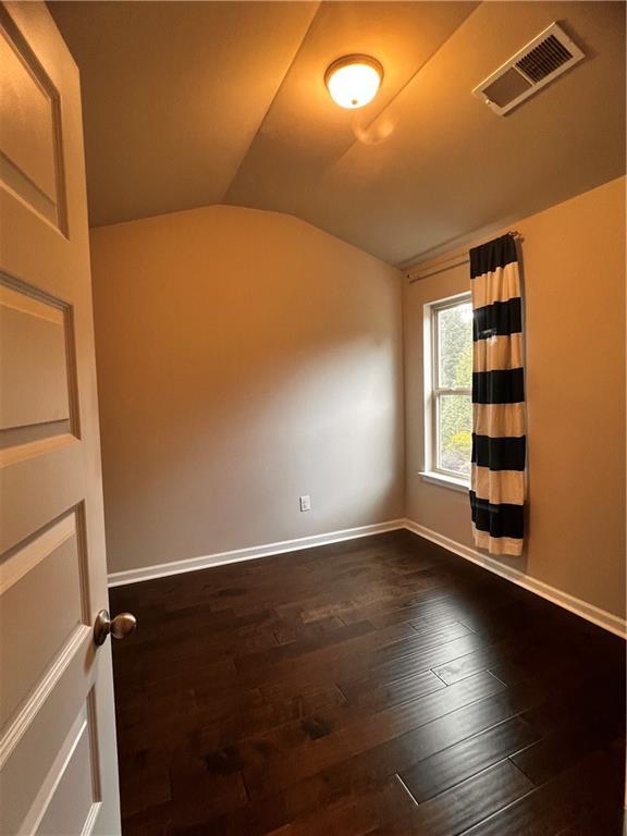 2778 Wild Laurel Ct, Norcross, GA 30071 - empty room with lofted ceiling, dark wood-style flooring, and baseboards
