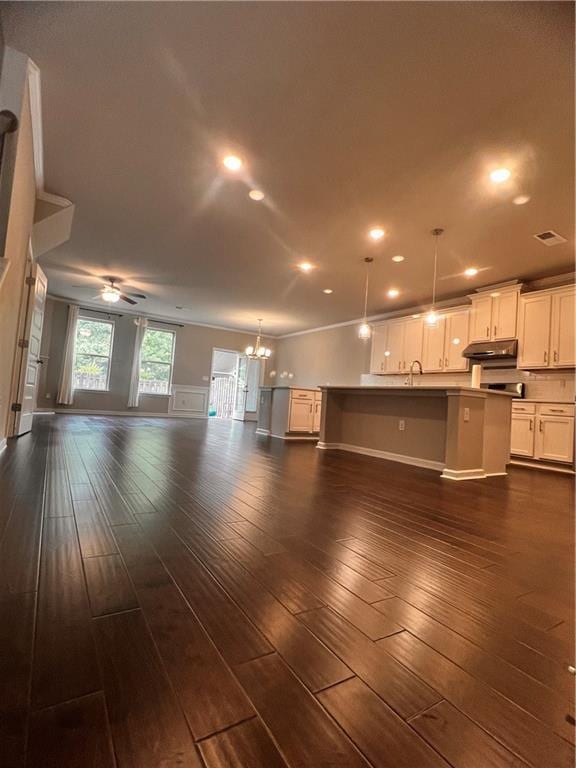 2778 Wild Laurel Ct, Norcross, GA 30071 - unfurnished living room with a ceiling fan, a sink, a chandelier, dark wood-type flooring, and recessed lighting
