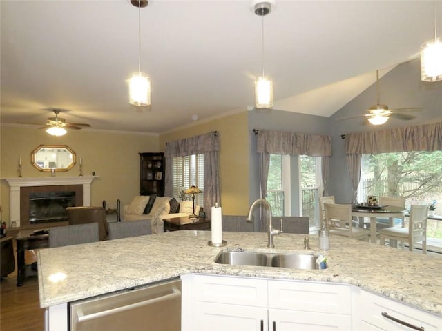 kitchen with white cabinetry, hanging light fixtures, sink, and dishwasher