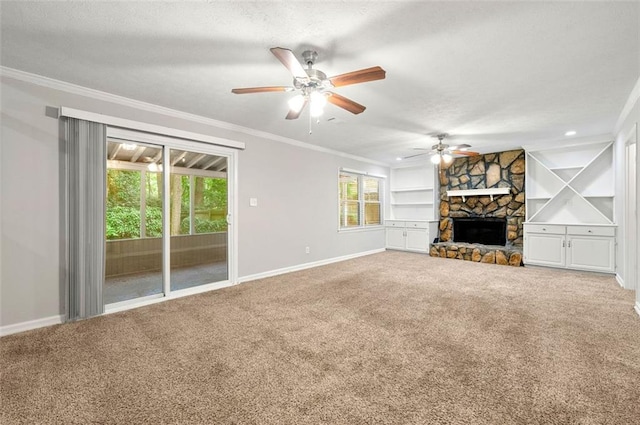 unfurnished living room with baseboards, carpet flooring, ornamental molding, a ceiling fan, and a textured ceiling