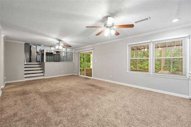 spare room with ceiling fan, carpet floors, baseboards, ornamental molding, and stairs