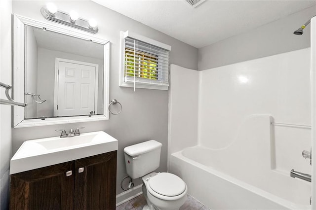 bathroom featuring toilet, vanity, baseboards, bathing tub / shower combination, and tile patterned floors