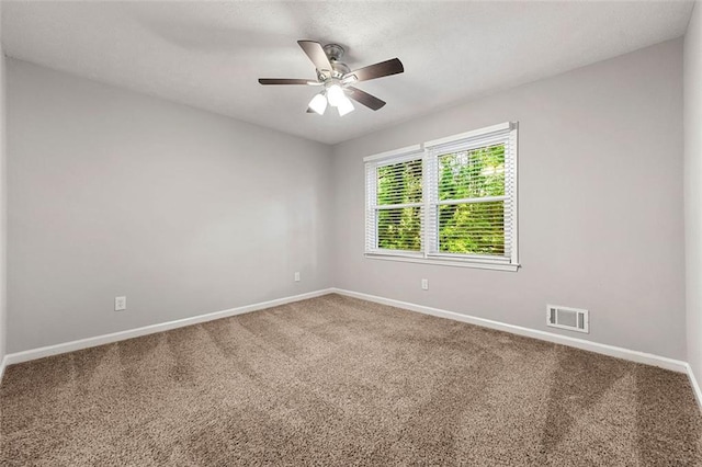 spare room with carpet, baseboards, and ceiling fan