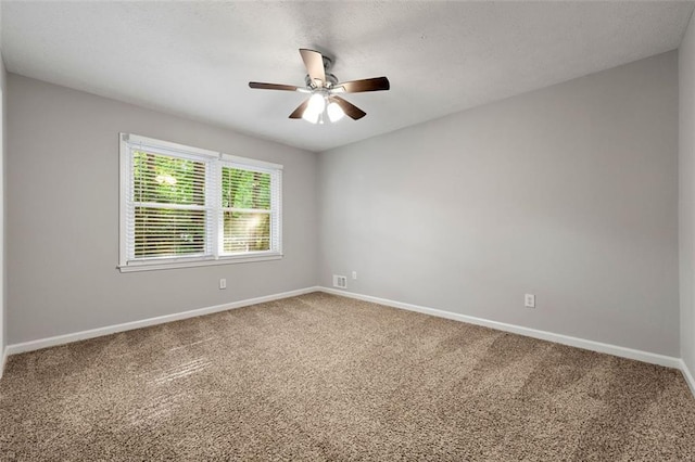empty room featuring carpet, baseboards, and ceiling fan