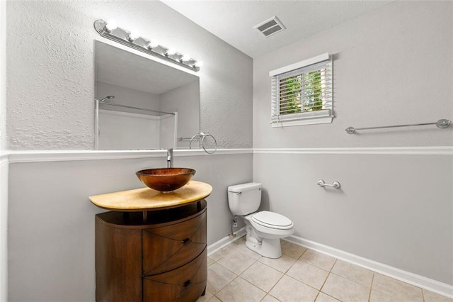 full bathroom featuring toilet, tile patterned floors, vanity, and baseboards