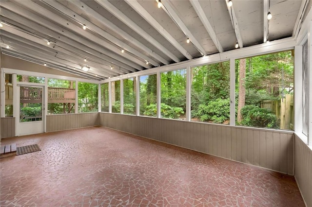unfurnished sunroom with lofted ceiling