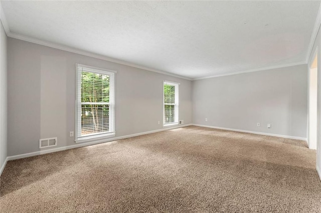 spare room with ornamental molding, carpet flooring, and baseboards