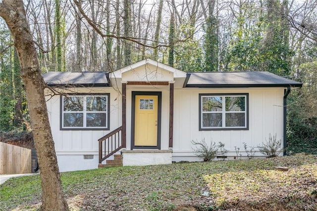 view of front of property featuring crawl space, fence, board and batten siding, and entry steps