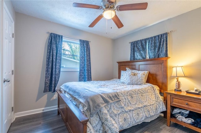 bedroom with a textured ceiling, ceiling fan, wood finished floors, and baseboards