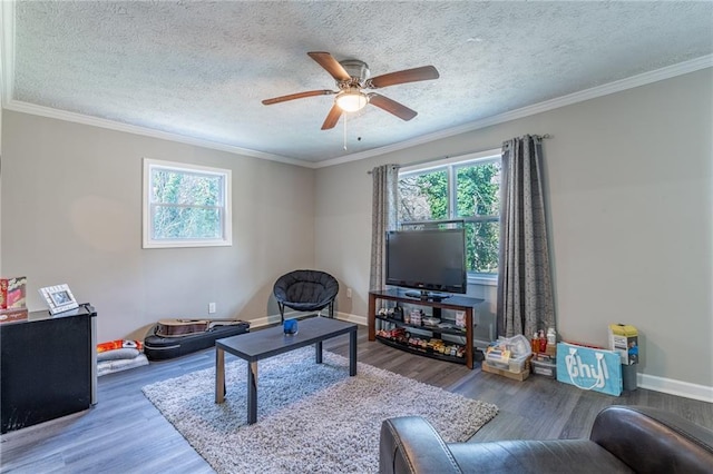 living room featuring ornamental molding, a healthy amount of sunlight, and wood finished floors