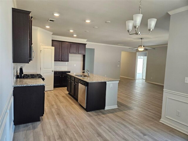 kitchen with a sink, visible vents, appliances with stainless steel finishes, light wood finished floors, and crown molding