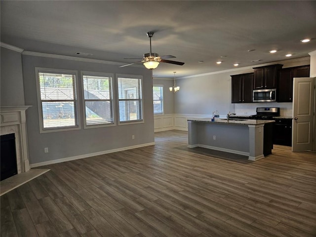 kitchen with open floor plan, stainless steel appliances, a fireplace, and dark wood-style floors