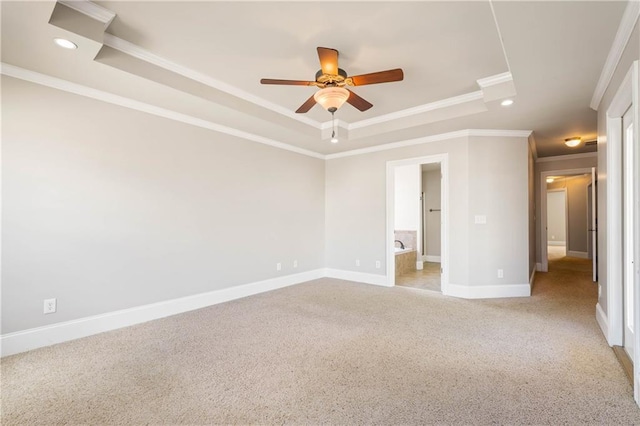 unfurnished bedroom featuring baseboards, a tray ceiling, and ornamental molding