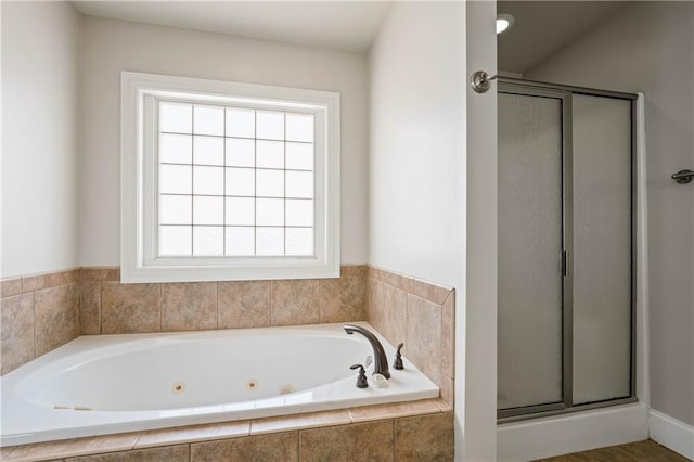 bathroom with a whirlpool tub and a shower stall