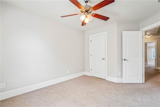 unfurnished bedroom with attic access, carpet, ceiling fan, and baseboards