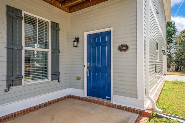 view of exterior entry with a porch