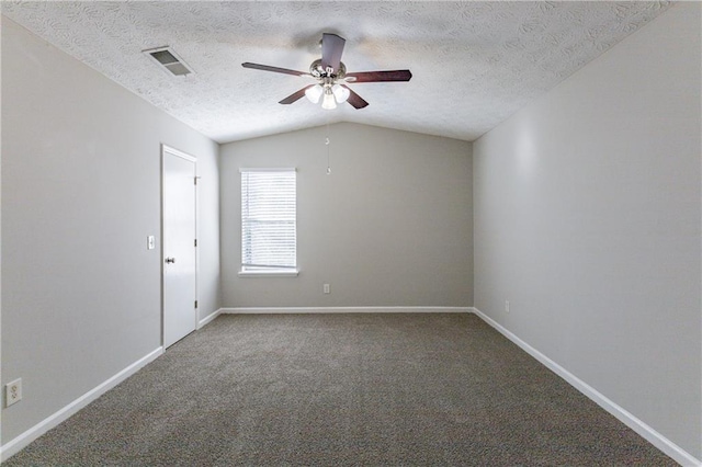 carpeted spare room featuring ceiling fan, a textured ceiling, and vaulted ceiling