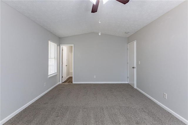 unfurnished room with a textured ceiling, ceiling fan, carpet, and vaulted ceiling