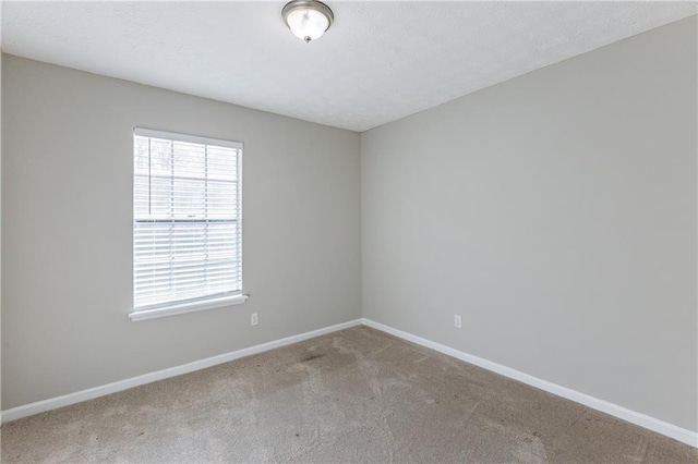 unfurnished room with light carpet