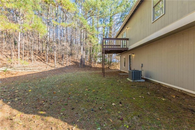 view of yard featuring a deck and central air condition unit