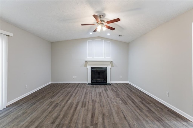 unfurnished living room featuring a textured ceiling, ceiling fan, dark hardwood / wood-style floors, and vaulted ceiling