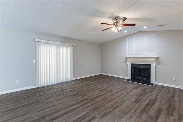 unfurnished living room with dark hardwood / wood-style flooring, a textured ceiling, vaulted ceiling, and ceiling fan