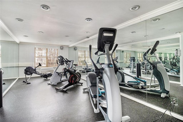 workout area featuring crown molding