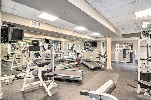 exercise room featuring a paneled ceiling