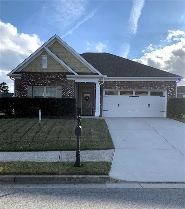 view of front of home featuring a garage and a front lawn