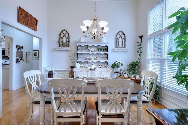 dining area with a chandelier and light hardwood / wood-style flooring