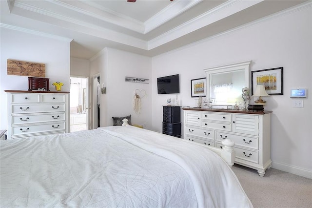 carpeted bedroom with crown molding and a raised ceiling