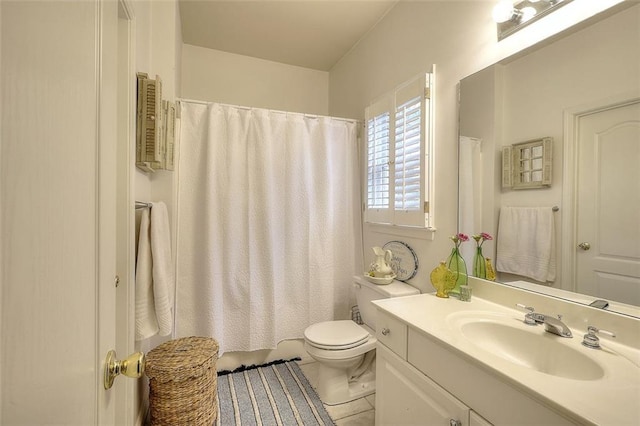 bathroom featuring toilet, vanity, and tile patterned floors