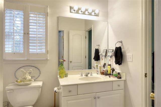 bathroom featuring toilet and vanity