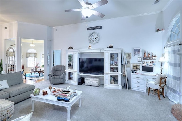 carpeted living room featuring ceiling fan and a towering ceiling