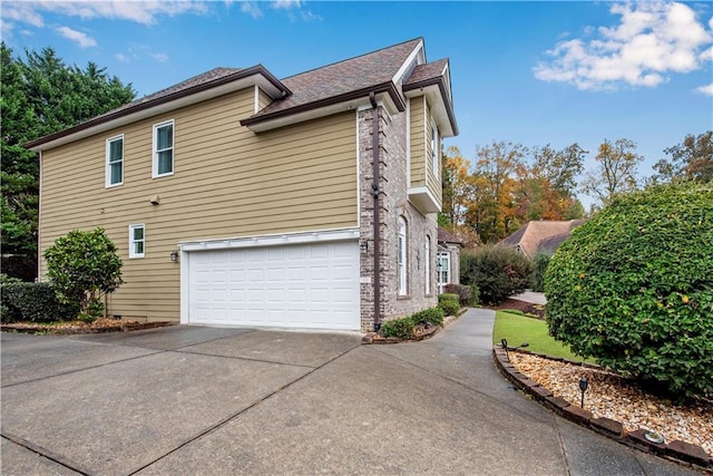 view of side of home featuring a garage