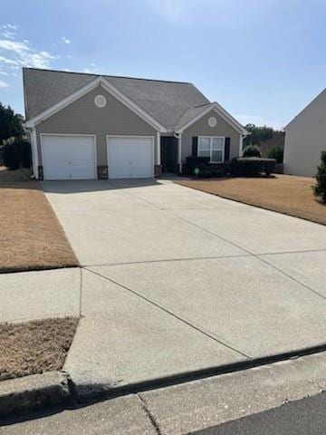 view of front of home with concrete driveway and a garage